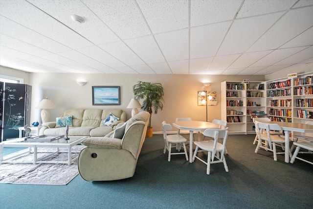 carpeted living room with a paneled ceiling