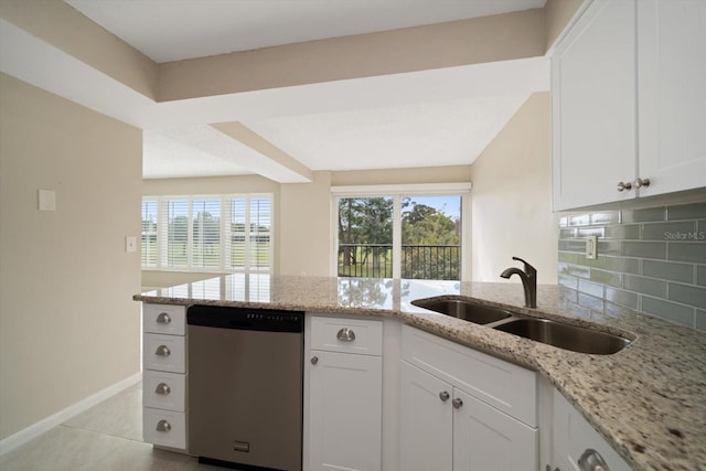 kitchen with white cabinetry, dishwasher, light stone countertops, sink, and tasteful backsplash