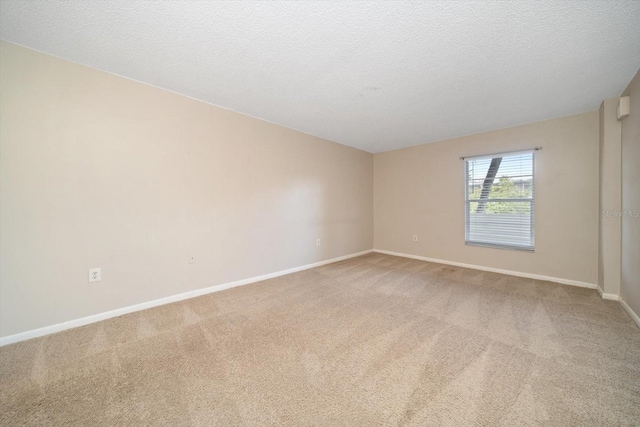 spare room with carpet floors and a textured ceiling