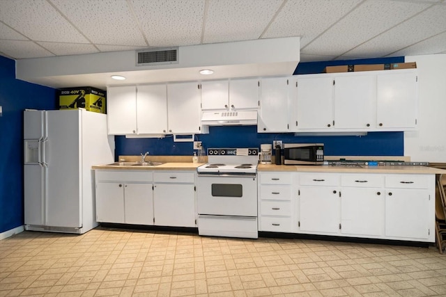 kitchen featuring white cabinets, a paneled ceiling, white appliances, and sink