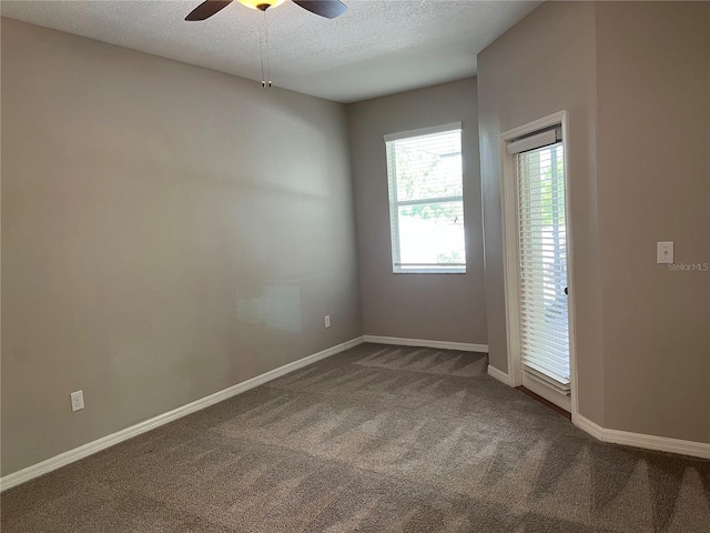 unfurnished room featuring carpet floors, a textured ceiling, and ceiling fan