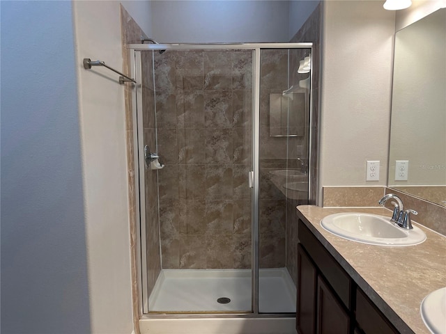 bathroom with walk in shower and vanity