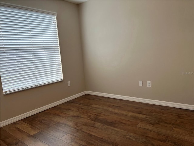 empty room with dark wood-type flooring