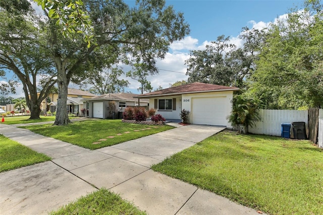 ranch-style house featuring a front lawn and a garage