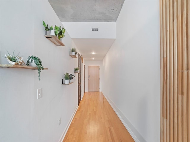 corridor with wood-type flooring