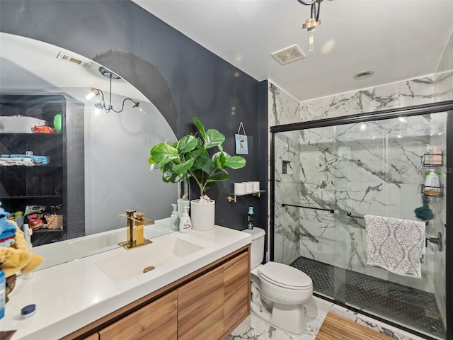 bathroom featuring vanity, toilet, and a shower with door