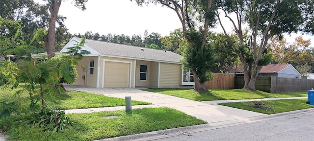 ranch-style home with a garage and a front lawn