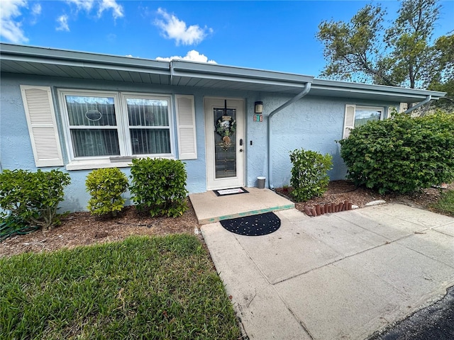 216 Gloucester Blvd Unit 216, Sun City Center, FL 33573 - doorway to property with stucco siding