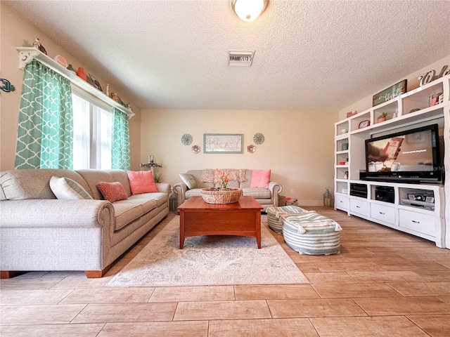 216 Gloucester Blvd Unit 216, Sun City Center, FL 33573 - living room featuring a textured ceiling, wood finish floors, and visible vents