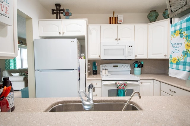 216 Gloucester Blvd Unit 216, Sun City Center, FL 33573 - kitchen featuring a sink, white cabinetry, white appliances, and light countertops