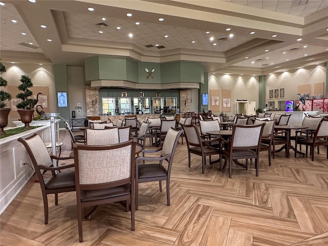 dining space with a tray ceiling and a high ceiling