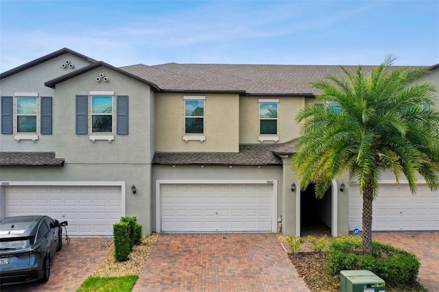 10012 Corso Milano Dr, Tampa, FL 33625 - multi unit property with stucco siding, driveway, a shingled roof, and a garage