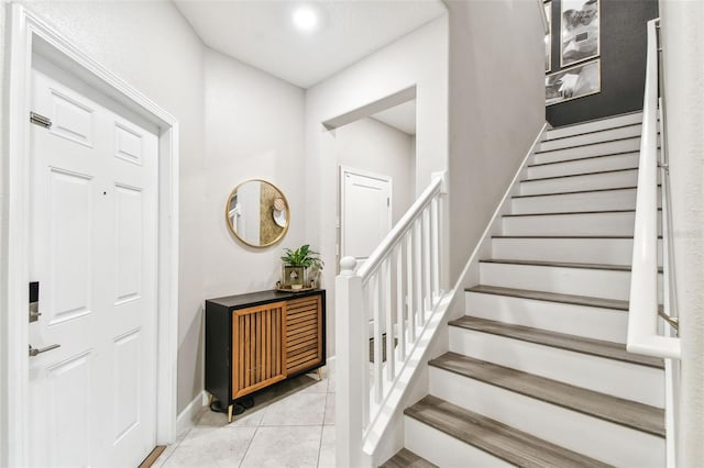 10012 Corso Milano Dr, Tampa, FL 33625 - entryway with baseboards, tile patterned flooring, and stairway