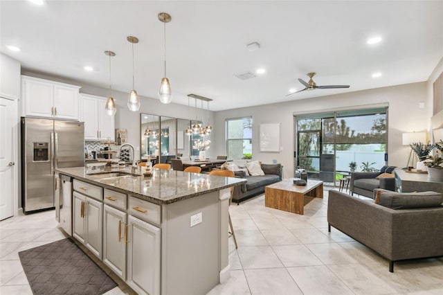 10012 Corso Milano Dr, Tampa, FL 33625 - kitchen with appliances with stainless steel finishes, a sink, a ceiling fan, open floor plan, and light tile patterned floors