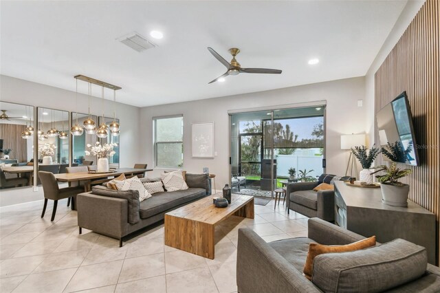 10012 Corso Milano Dr, Tampa, FL 33625 - living room with a ceiling fan, visible vents, light tile patterned floors, and recessed lighting