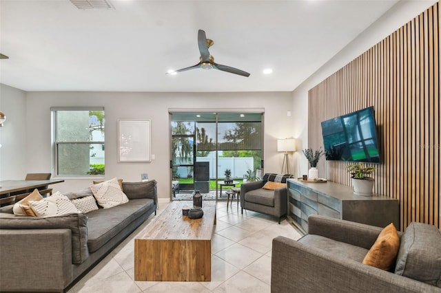 tiled living room featuring ceiling fan