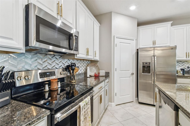 10012 Corso Milano Dr, Tampa, FL 33625 - kitchen with appliances with stainless steel finishes, white cabinets, and tasteful backsplash