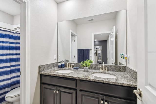 10012 Corso Milano Dr, Tampa, FL 33625 - full bathroom with a sink, toilet, double vanity, and visible vents