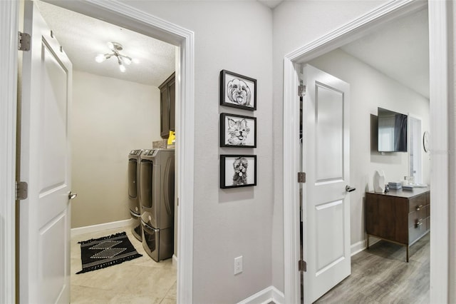 interior space with a textured ceiling, light hardwood / wood-style flooring, and independent washer and dryer