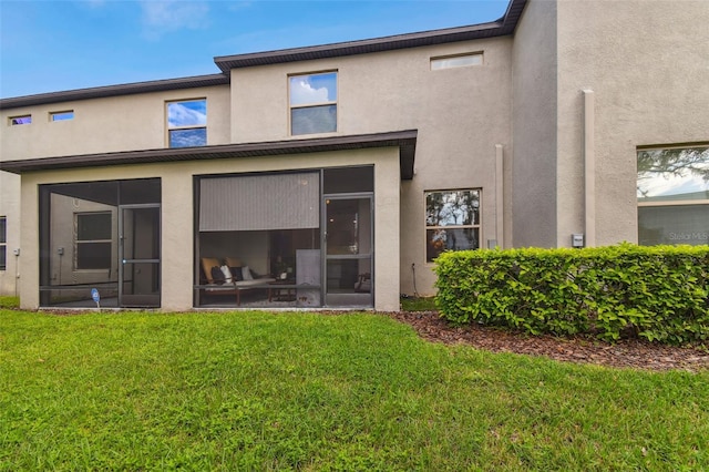 10012 Corso Milano Dr, Tampa, FL 33625 - back of house with a yard, stucco siding, and a sunroom