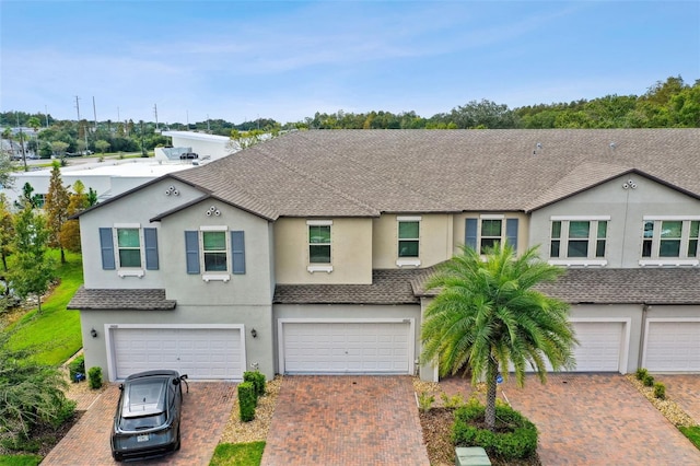 10012 Corso Milano Dr, Tampa, FL 33625 - view of front of property with a shingled roof, an attached garage, driveway, and stucco siding