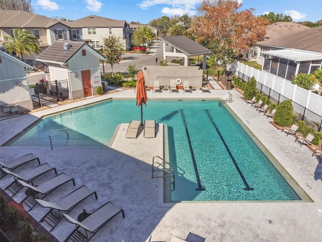 view of swimming pool featuring a patio and an outbuilding