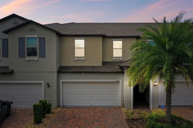 10012 Corso Milano Dr, Tampa, FL 33625 - view of property with an attached garage, decorative driveway, roof with shingles, and stucco siding