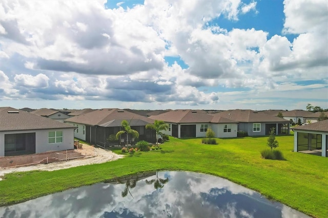 rear view of house featuring a yard