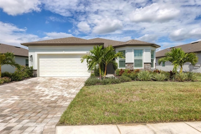 view of front of home featuring a front yard and a garage