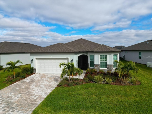 view of front facade featuring a garage and a front lawn