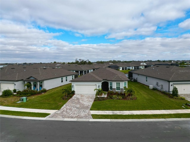 view of front of property featuring a front yard and a garage