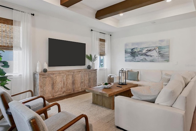 living room with a healthy amount of sunlight, beamed ceiling, and light hardwood / wood-style floors