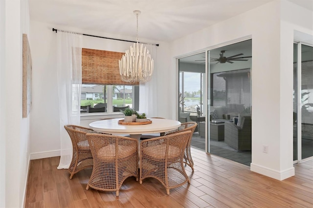 dining space featuring light hardwood / wood-style floors and a notable chandelier