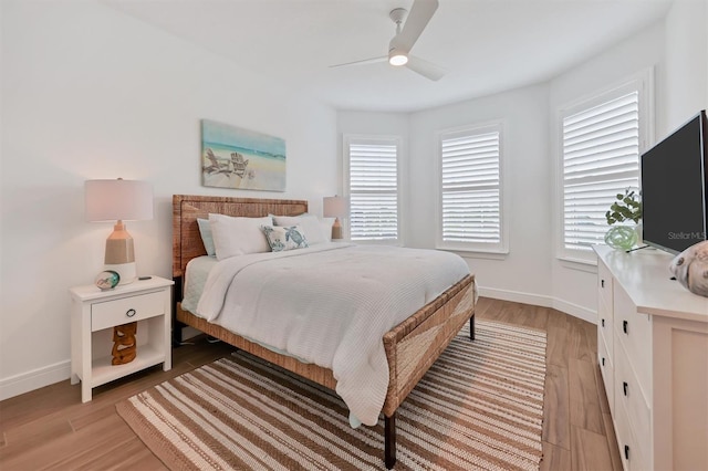 bedroom with light hardwood / wood-style floors and ceiling fan