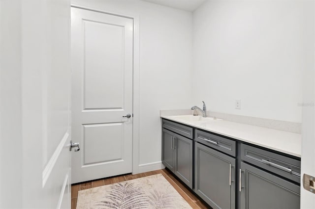 bathroom with vanity and wood-type flooring