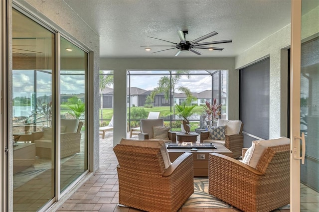 sunroom with ceiling fan