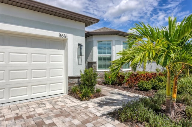 view of exterior entry featuring a garage