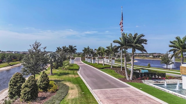 view of community featuring a yard and a water view