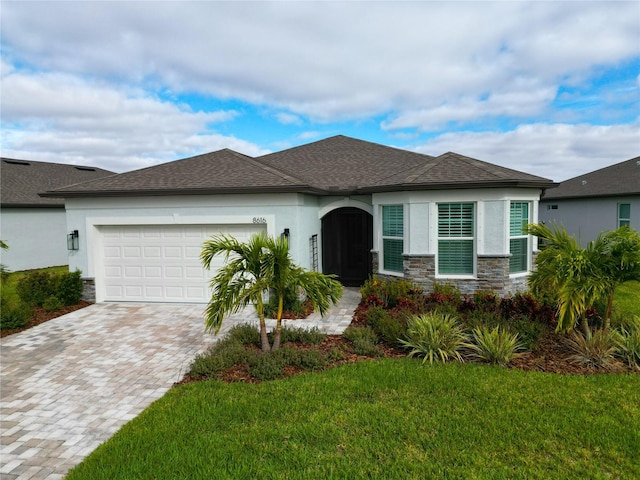 view of front facade with a garage and a front lawn