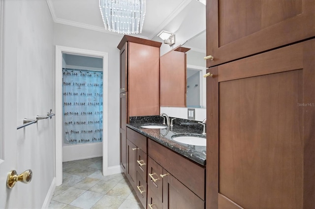 bathroom with double vanity, tile patterned floors, a sink, and crown molding