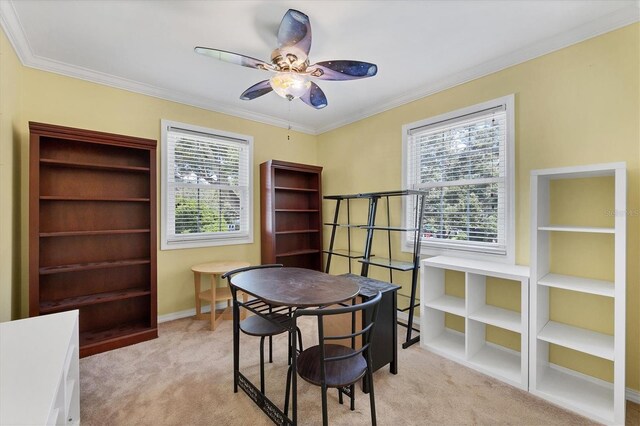 office area with ornamental molding, light carpet, ceiling fan, and baseboards