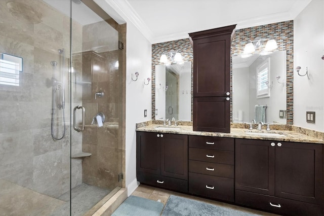 full bathroom with double vanity, ornamental molding, a sink, and a shower stall