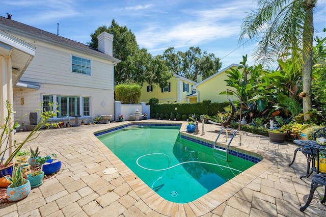 view of pool with a patio area, fence, and a fenced in pool