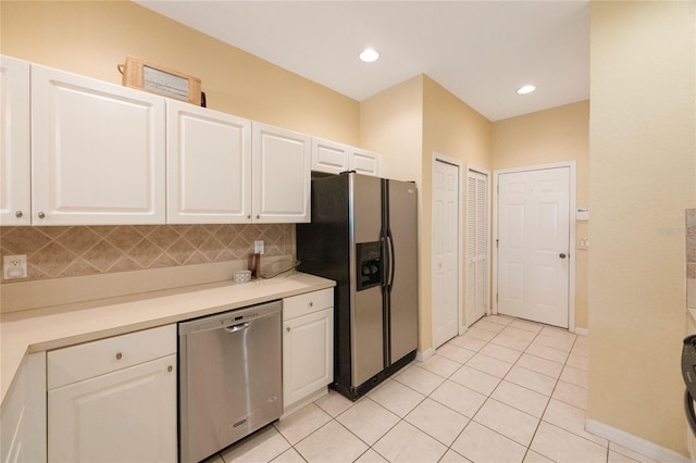 kitchen with backsplash, appliances with stainless steel finishes, and white cabinets