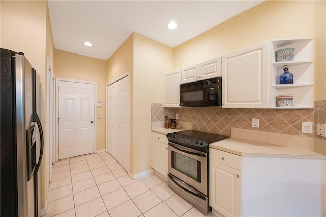 kitchen with white cabinets, stainless steel appliances, light tile patterned flooring, and tasteful backsplash