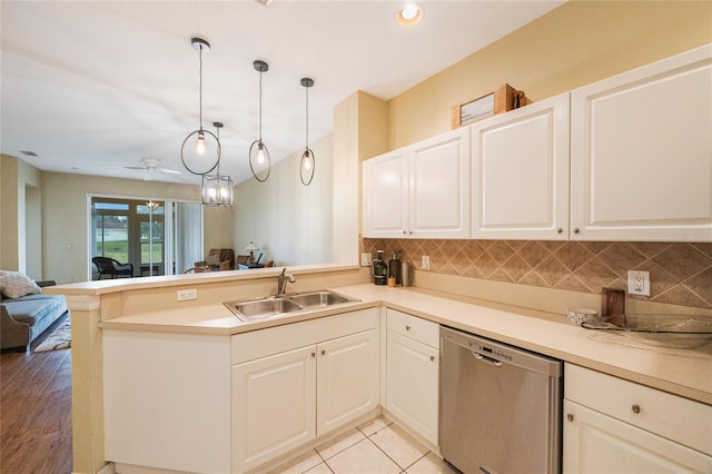 kitchen featuring light hardwood / wood-style floors, sink, kitchen peninsula, decorative light fixtures, and dishwasher