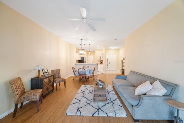 living room with ceiling fan and light wood-type flooring