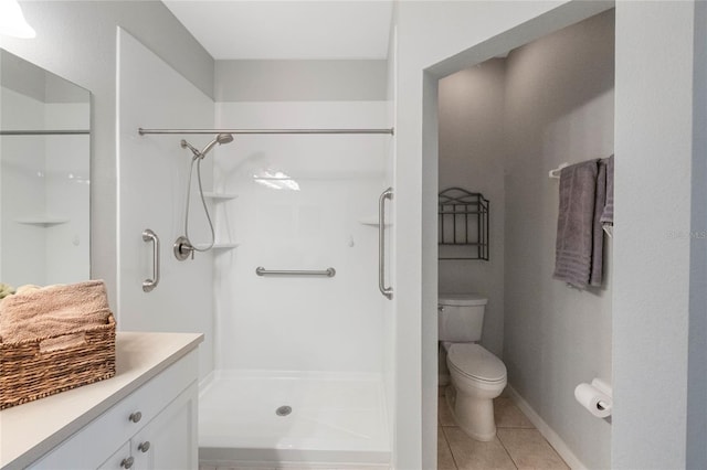 bathroom featuring toilet, vanity, an enclosed shower, and tile patterned flooring