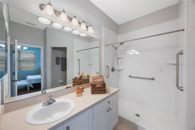 bathroom featuring walk in shower, vanity, and tile patterned flooring