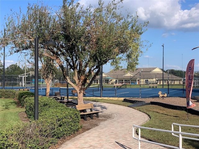 surrounding community featuring tennis court